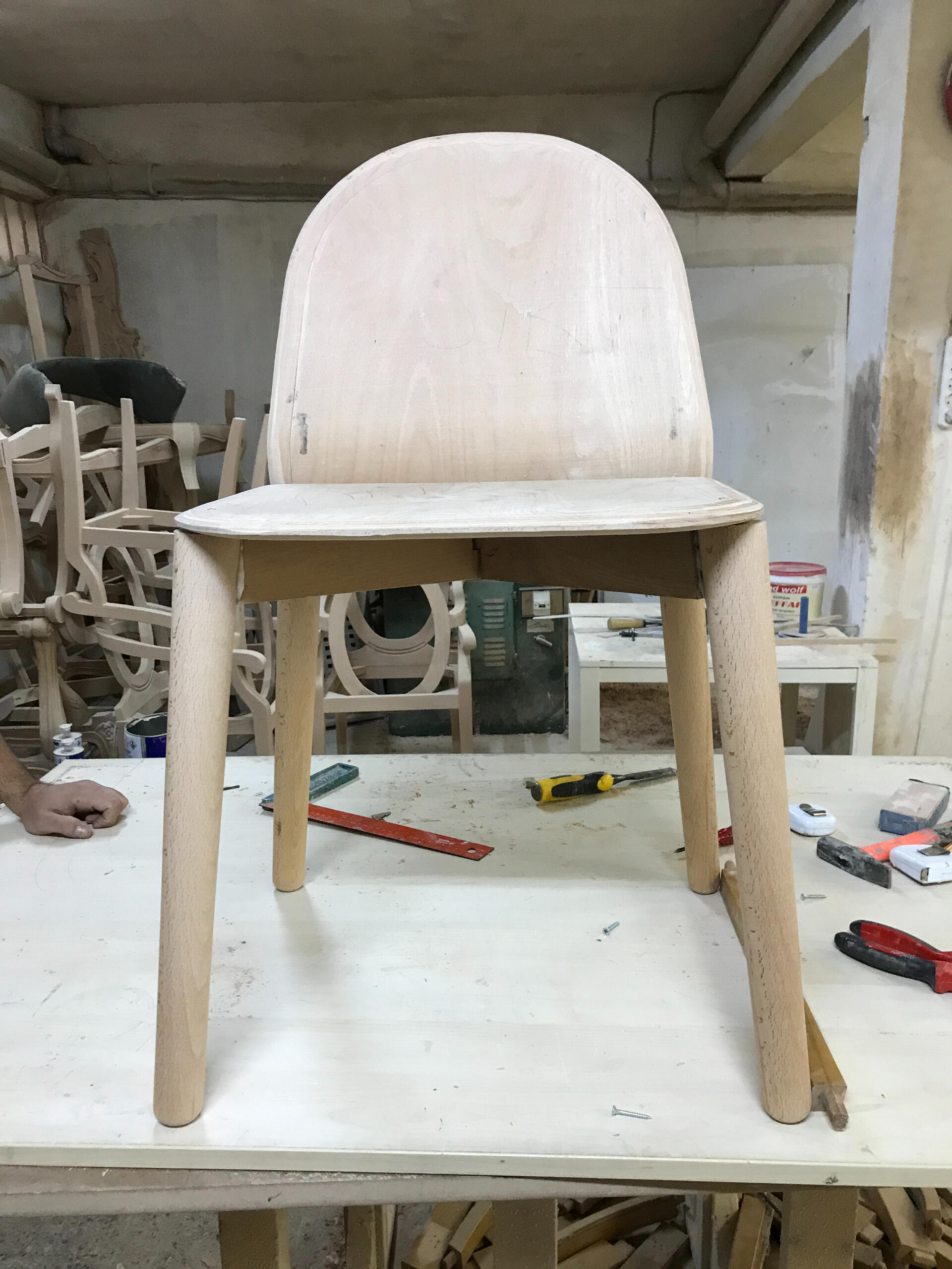 Bent ply chair front view on work bench